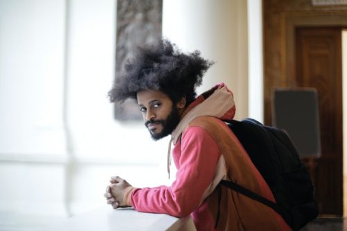 man in pink sweater wearing black backpack, alcohol detox Los Angeles Cali, alcohol rehabilitation in Los Angeles Cali