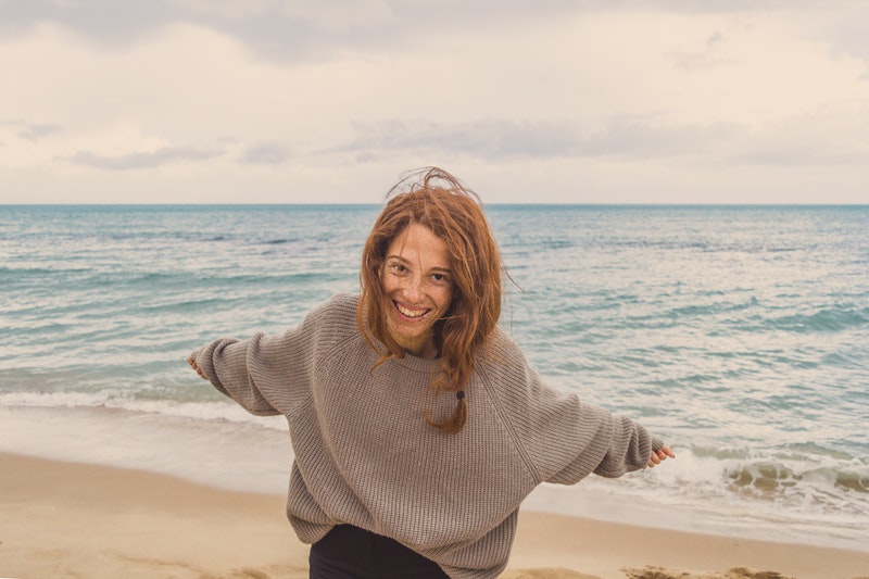 woman having fun by the sea after aa meeting 